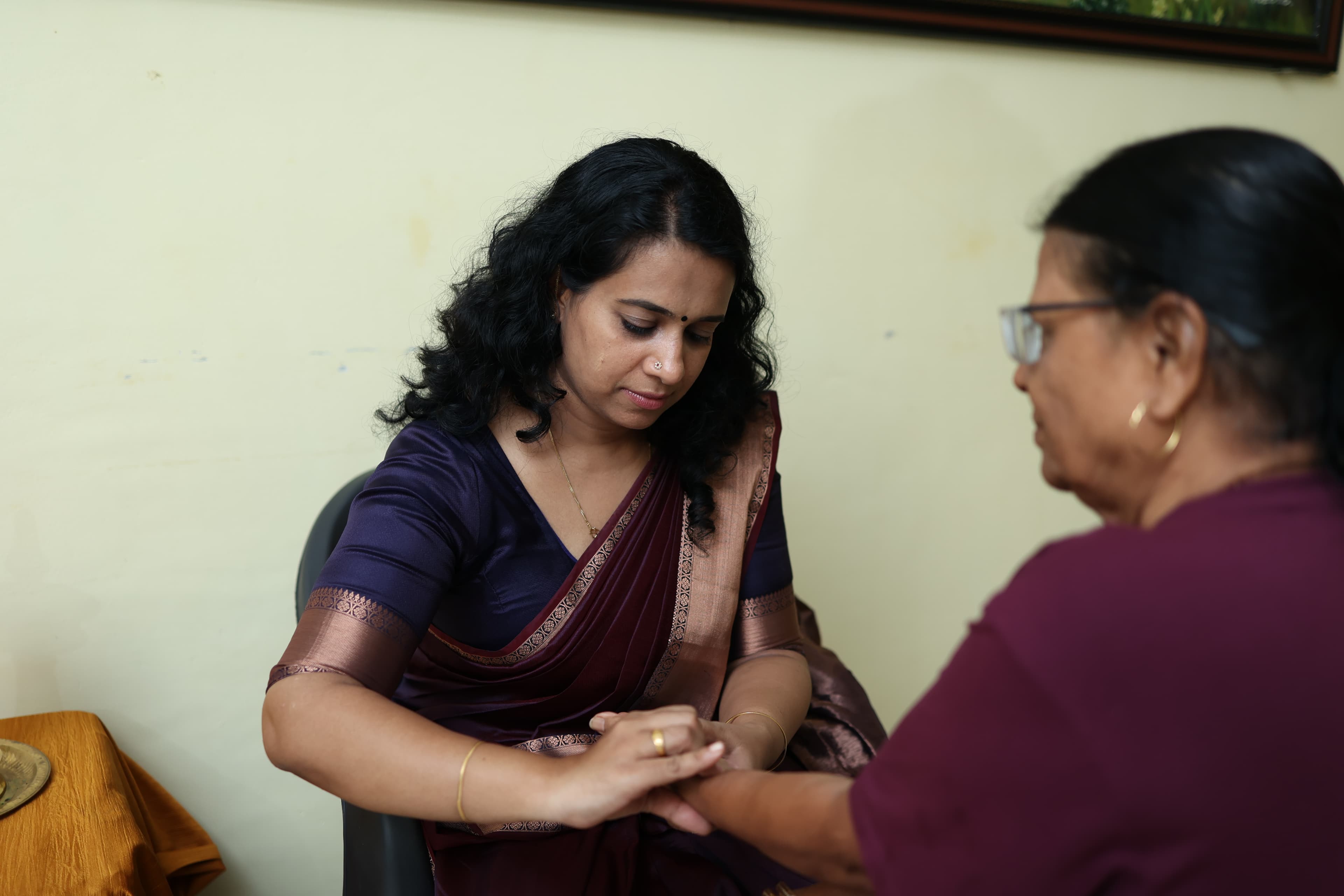 Close-up of a practitioner working with a patient's hand